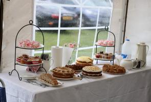 A fine spread of sandwiches, cakes & scones.